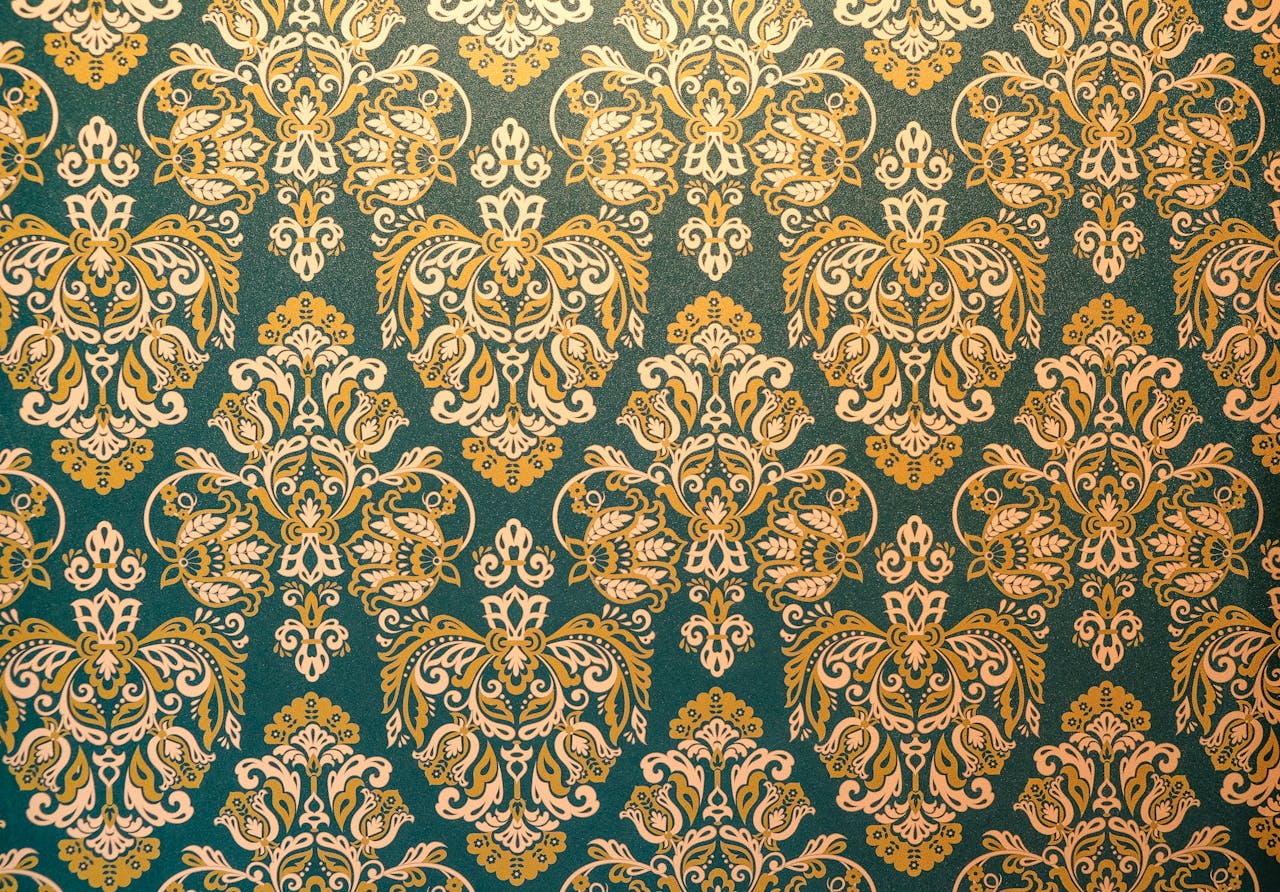 Elegant damask wallpaper with gold and white patterns on a green background, perfect for vintage decor.